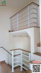 White wooden staircase with handrails in a modern home