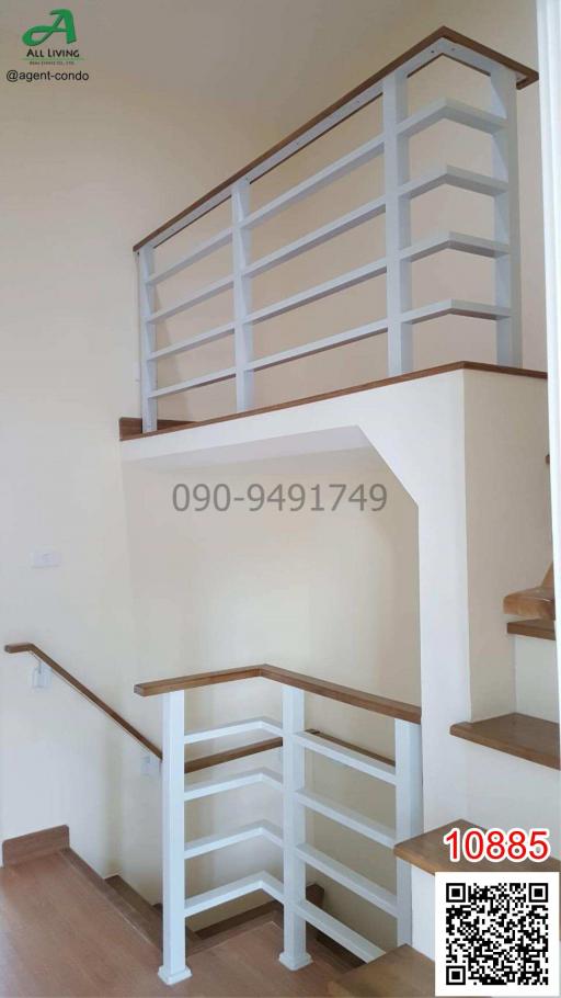 White wooden staircase with handrails in a modern home