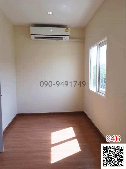 Empty bedroom with air conditioning unit and hardwood flooring