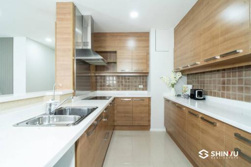 Modern kitchen with wooden cabinets and white countertops