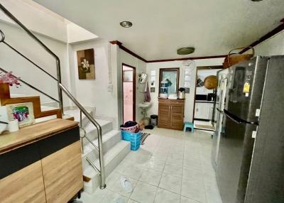 Interior view of a home with staircase and kitchen appliances