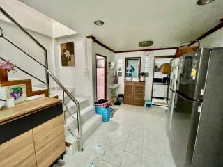 Interior view of a home with staircase and kitchen appliances