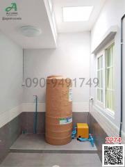 Storage space or utility room with unpacked items and contact information