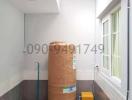 Storage space or utility room with unpacked items and contact information