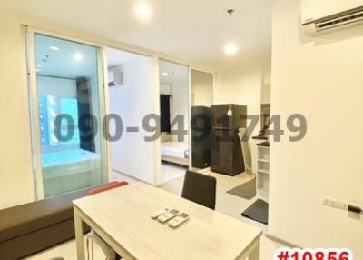 Bright modern dining area with table set and access to balcony