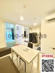 Bright modern dining area with table set and access to balcony