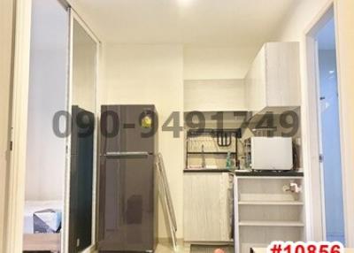 Compact kitchen with modern appliances and adjacent bedroom entry