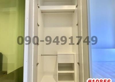 Compact built-in white wardrobe with shelves and storage spaces