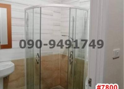 Modern bathroom with glass shower enclosure and white tiles