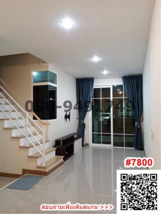 Modern living room interior with a staircase and glossy tiled flooring