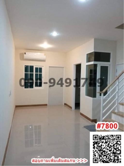 Spacious living room with tiled floor and modern lighting