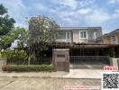 Contemporary two-story house with a gated entrance and landscaped front yard