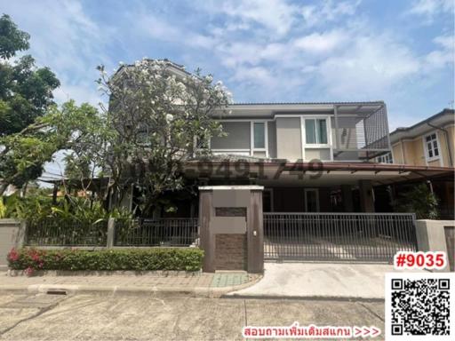 Contemporary two-story house with a gated entrance and landscaped front yard