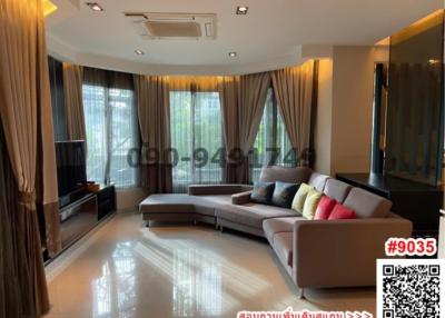Spacious and modern living room with large windows and ample lighting