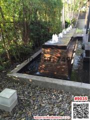 Tranquil garden with water feature and lush greenery