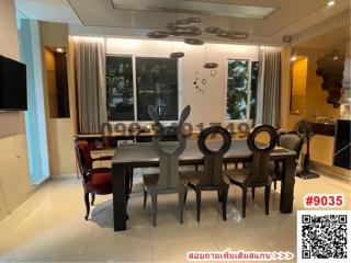 Modern dining room with a large table and chairs, well-lit interior