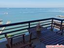 Spacious balcony with ocean view and outdoor seating