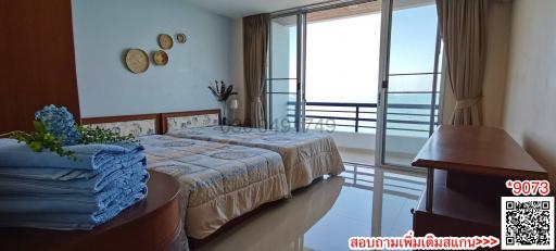 Spacious bedroom with ocean view and balcony access