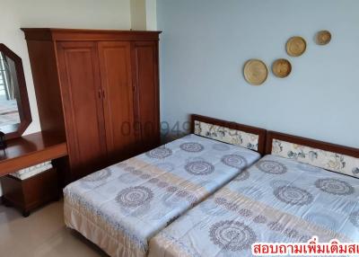 Spacious bedroom with double bed and wooden furniture