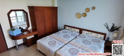 Spacious bedroom with double bed and wooden furniture