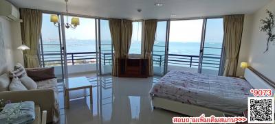 Spacious bedroom with ocean view and balcony access