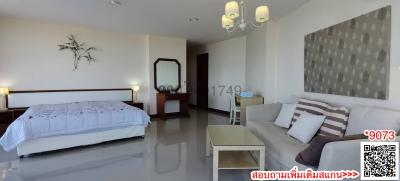 Spacious bedroom with an adjacent sitting area and modern decor