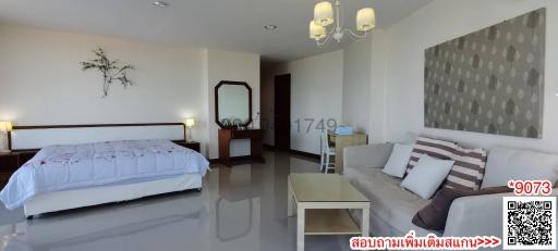 Spacious bedroom with an adjacent sitting area and modern decor
