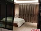 Modern bedroom with wooden flooring and recessed lighting