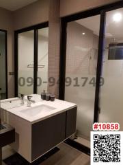 Modern bathroom interior with glass shower and vanity