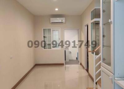 Modern and bright corridor with glossy tiled flooring and built-in glass door storage