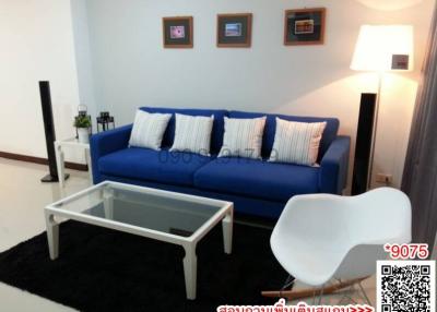 Cozy and modern living room with blue sofa and white furniture