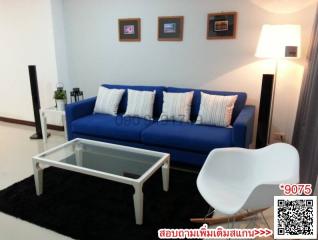 Cozy and modern living room with blue sofa and white furniture