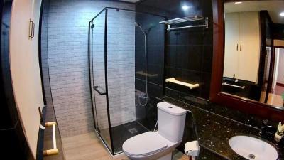 Modern bathroom with glass shower and black countertops