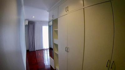 Spacious bedroom with large built-in wardrobe and hardwood flooring