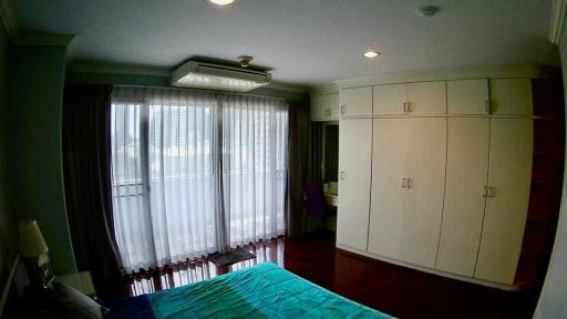 Spacious bedroom with large built-in wardrobe and ample natural light