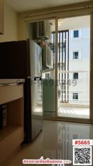 Compact kitchen space with refrigerator and window