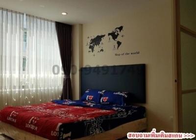 Cozy bedroom with world map wall decor and large window