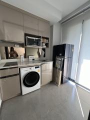 Modern kitchen with appliances and ample natural light