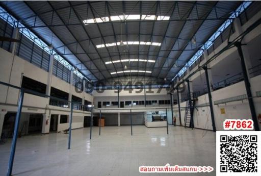 Spacious industrial building interior with high ceiling and skylights