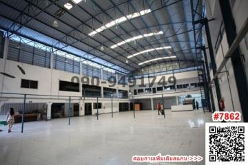 Spacious industrial warehouse interior with high ceiling and office space