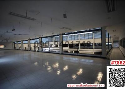 Large open space with multiple windows and reflective flooring