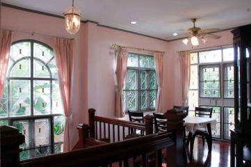 Elegant living room with large windows and traditional decor