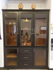Elegant wooden display cabinet with glass doors in a living room