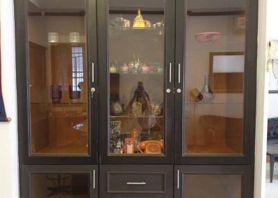 Elegant wooden display cabinet with glass doors in a living room