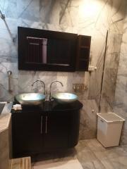 Modern bathroom with double vessel sinks and marble walls