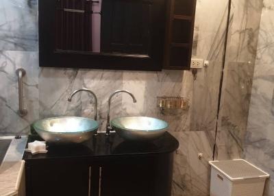 Modern bathroom with double vessel sinks and marble walls