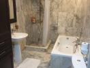 Marble tiled bathroom with bathtub and shower