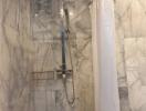 Modern marble-walled bathroom with a rainfall shower head