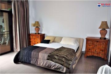 Spacious bedroom with queen-sized bed and classic wooden furniture