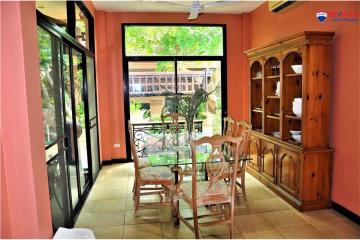 Bright dining room with large windows and garden view